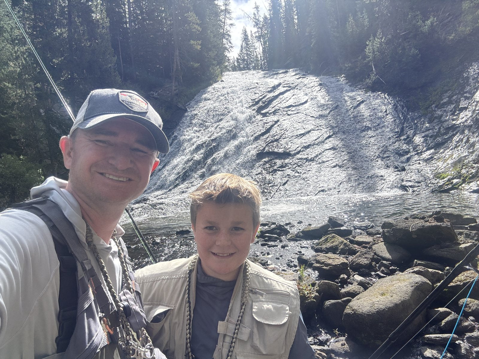 Trevor and Caden in front of a backcountry waterfall